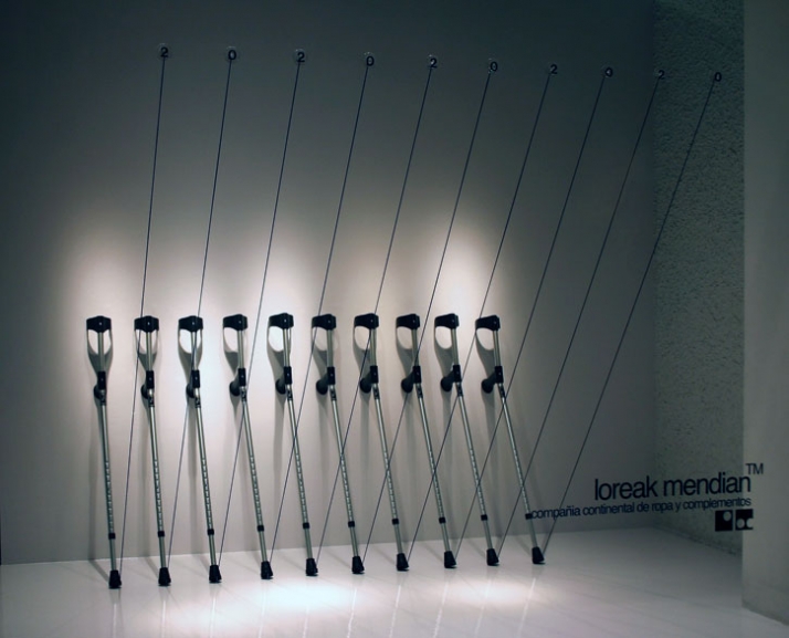 Sale. A Stark row of crutches accentuated with a like number of elasticized black cords. photo by Ion Ander Beloki