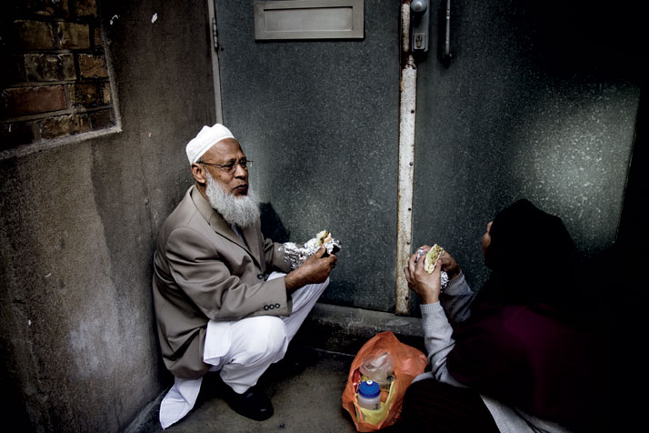 September 2011 // A man and woman eat lunch in a doorway off a side street in Shoreditch.photo © Brian Leli