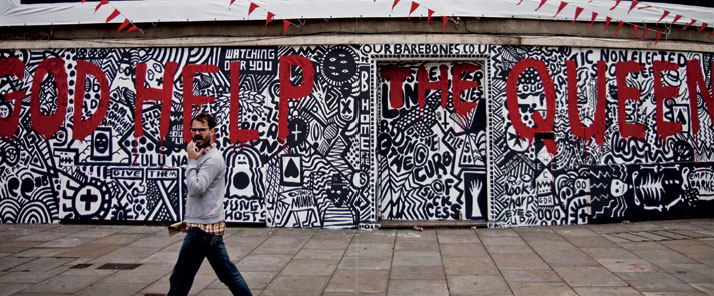 June 2012 // A man walks past a wall covered in street art during the Queen’s Diamond Jubilee.photo © Brian Leli