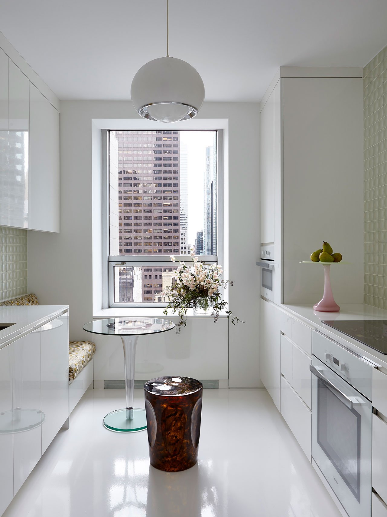 Vintage suspension lamp "Bud" Model 3029 by Luigi Massoni for Harvey Guzzini; “Lonia” glass dining table by LeisureMod; “Scottie” Stool by Pinto Paris via Maison Gerard.
Photography by Joshua McHugh.