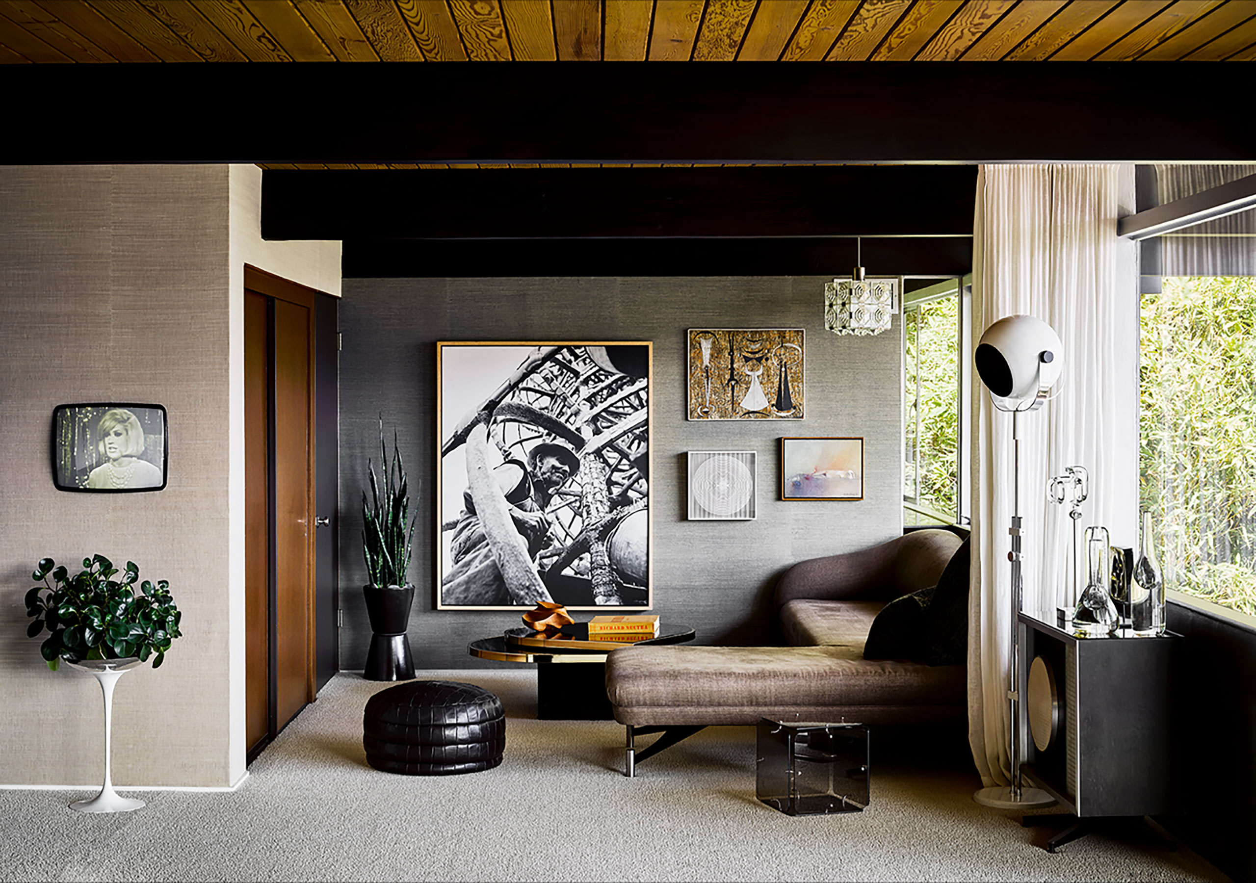 Photography by Douglas Friedman.
Featured: Swan sofa by Vladimir Kagan; original built-in TV, Eames Speaker used as side table; glass cube table by Gerard McCabe; leather patchwork ottoman by DeSede.