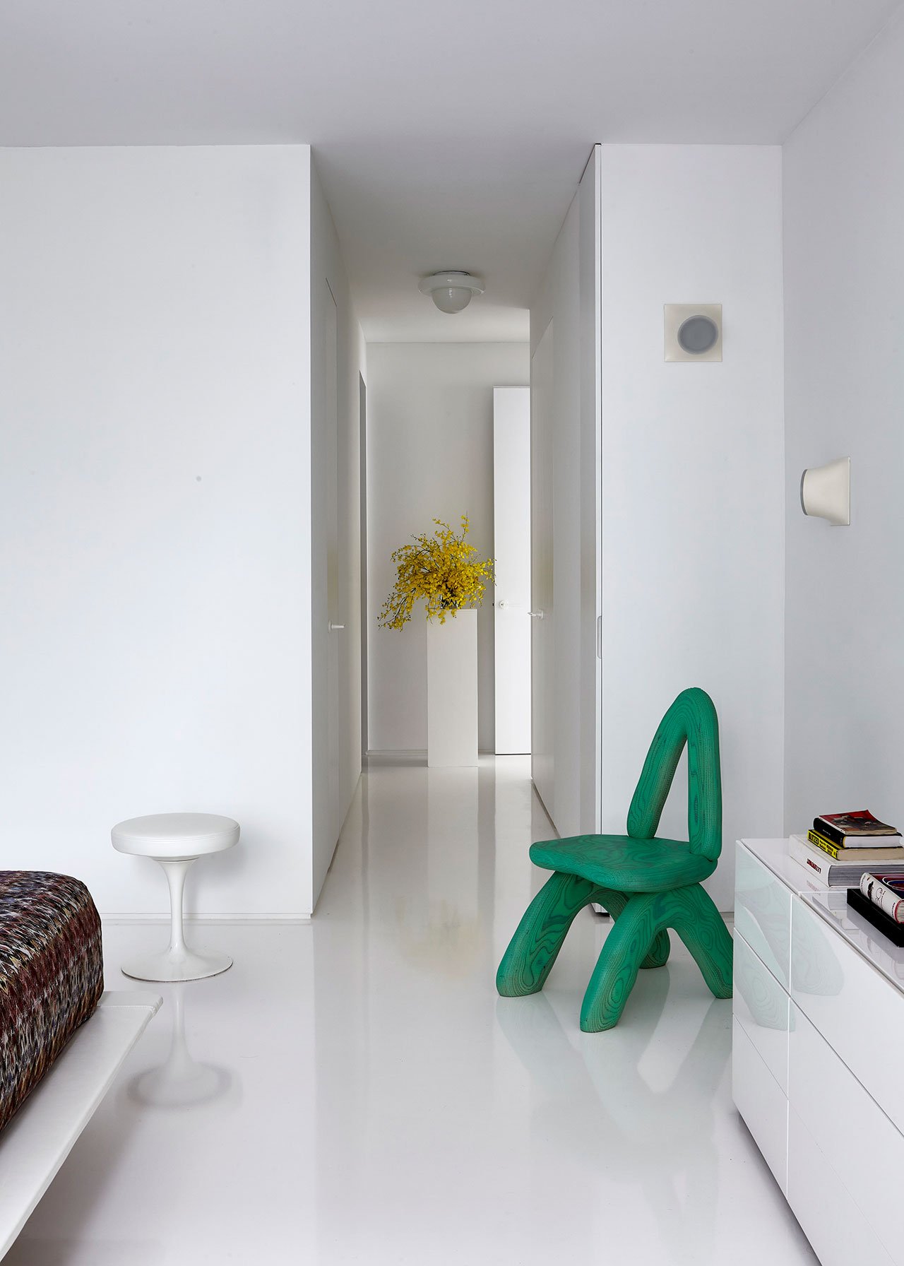 Vintage "Tulip stool" by Eero Saarinen with seat newly reupholstered in white leather; “Dino Chair” by Daniel Arsham, via Friedman Benda; Vintage wall sconce by Giotto Stoppino (1970s).
Photography by Joshua McHugh.