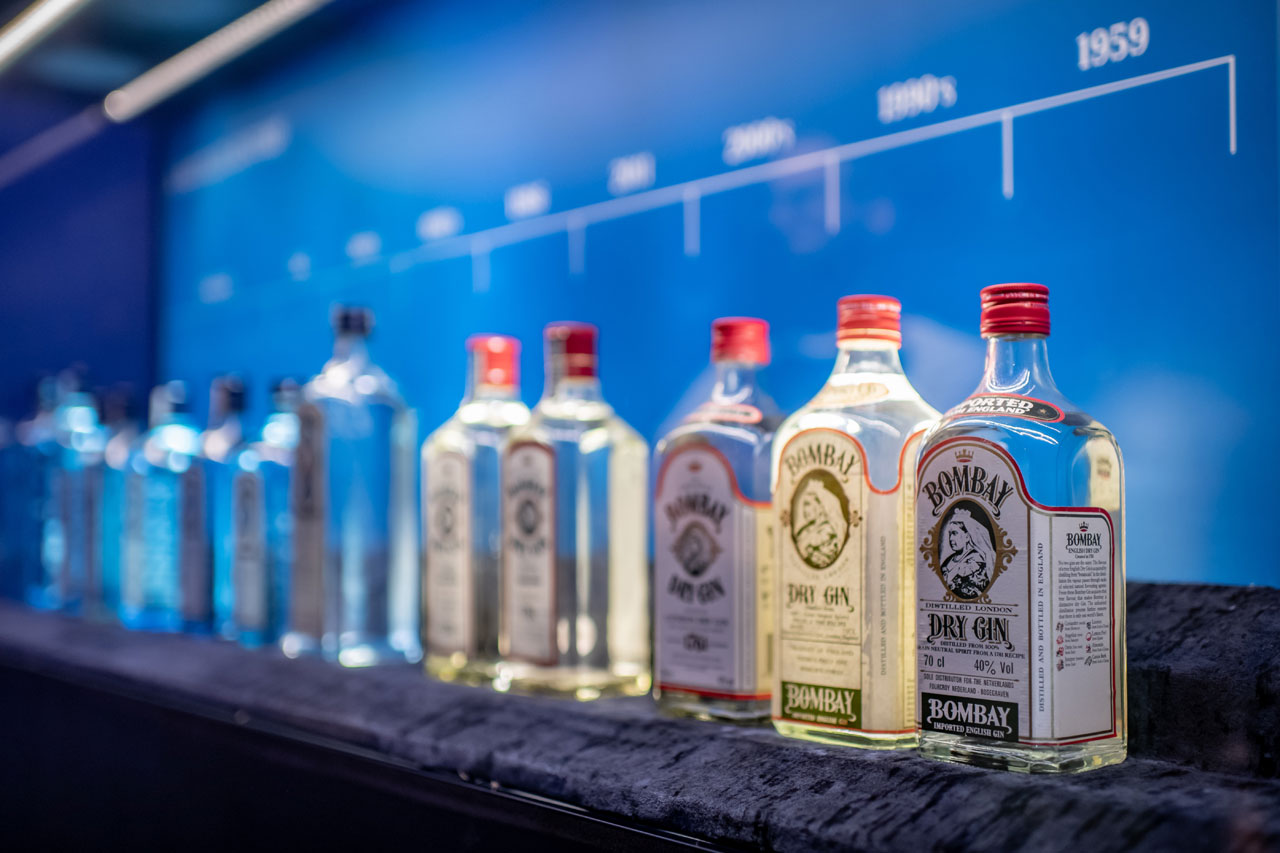 The evolution of Bombay Sapphire bottles at the Museum of the gin's distillery at Laverstoke Mill. Installattion view by Elias Joidos © Yatzerland Ltd.