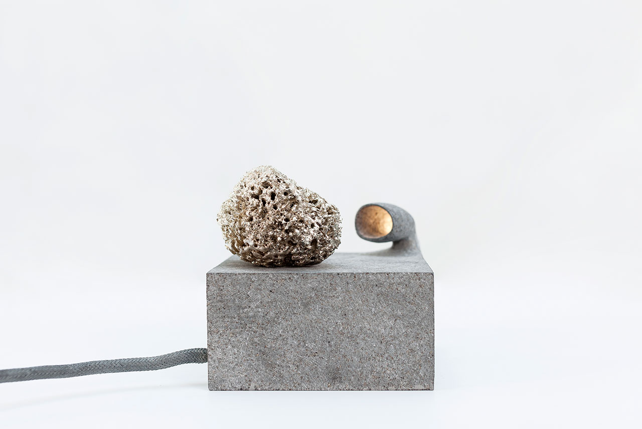 ROCK by Najla El Zein. Basalt, led, glass, sea sponge, silver. 14 x 14 x 13.5 cm.