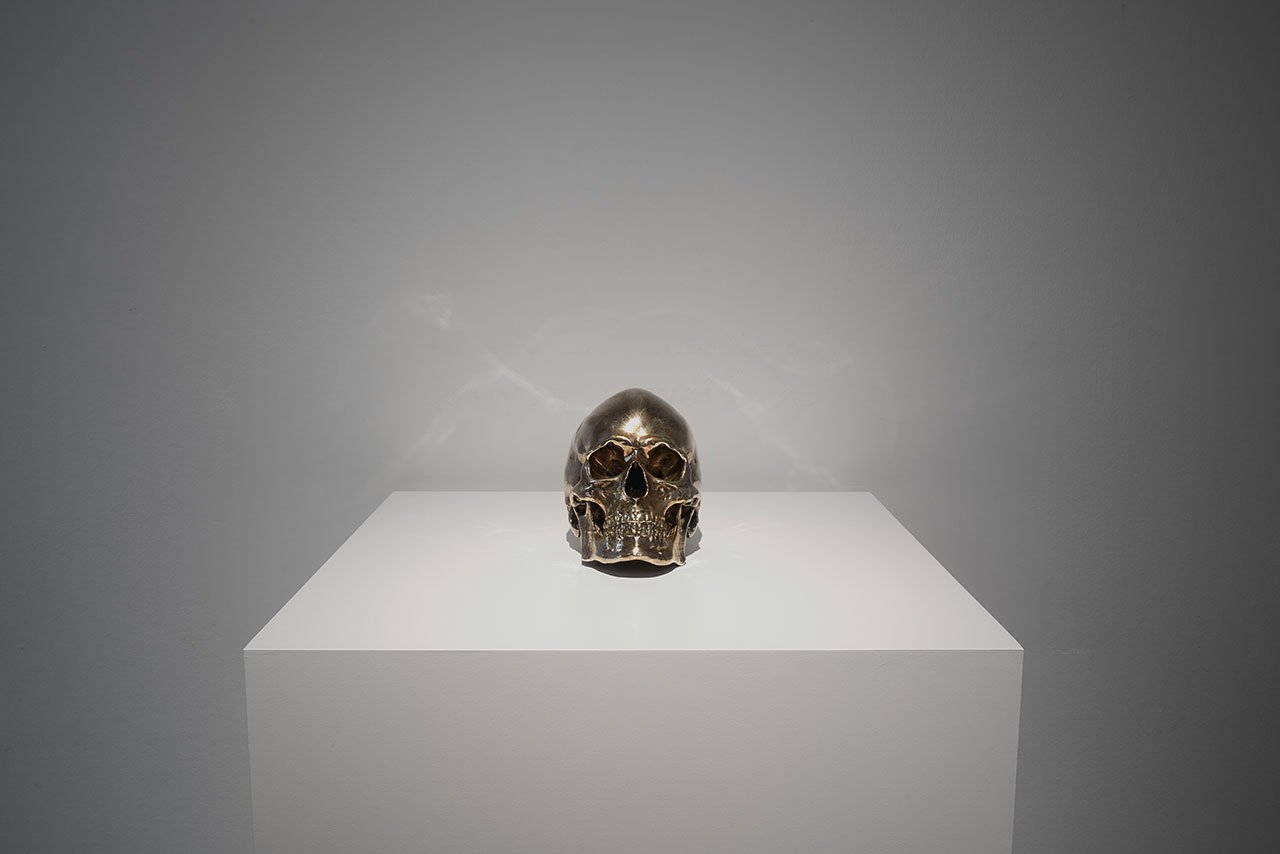 Installation view. Kris Martin, EXIT at S.M.A.K., Ghent, 2020. Photo by Dirk Pauwels.
Featured: Still Alive, 2005. Bronze, silver-plated. Courtesy of the artist.
Artist's statement: I had my skull scanned, plotted, cast and silvered. It’s the first skull of a living human being in art history.